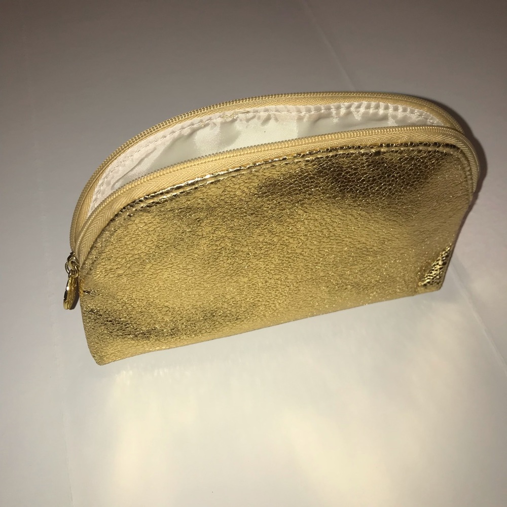 Gold Estee Lauder makeup bag